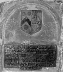 On the east wall of the Chancel is a monument of Bethersden marble containing two brass plates-an inscription , and above it a coat of arms